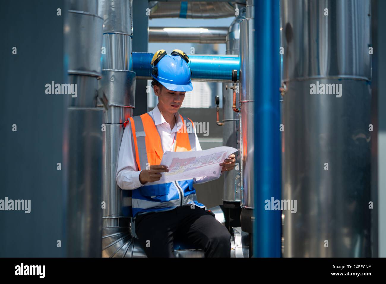 Engineers inspect the completed air conditioning and water systems to continue verifying their functionality. Stock Photo