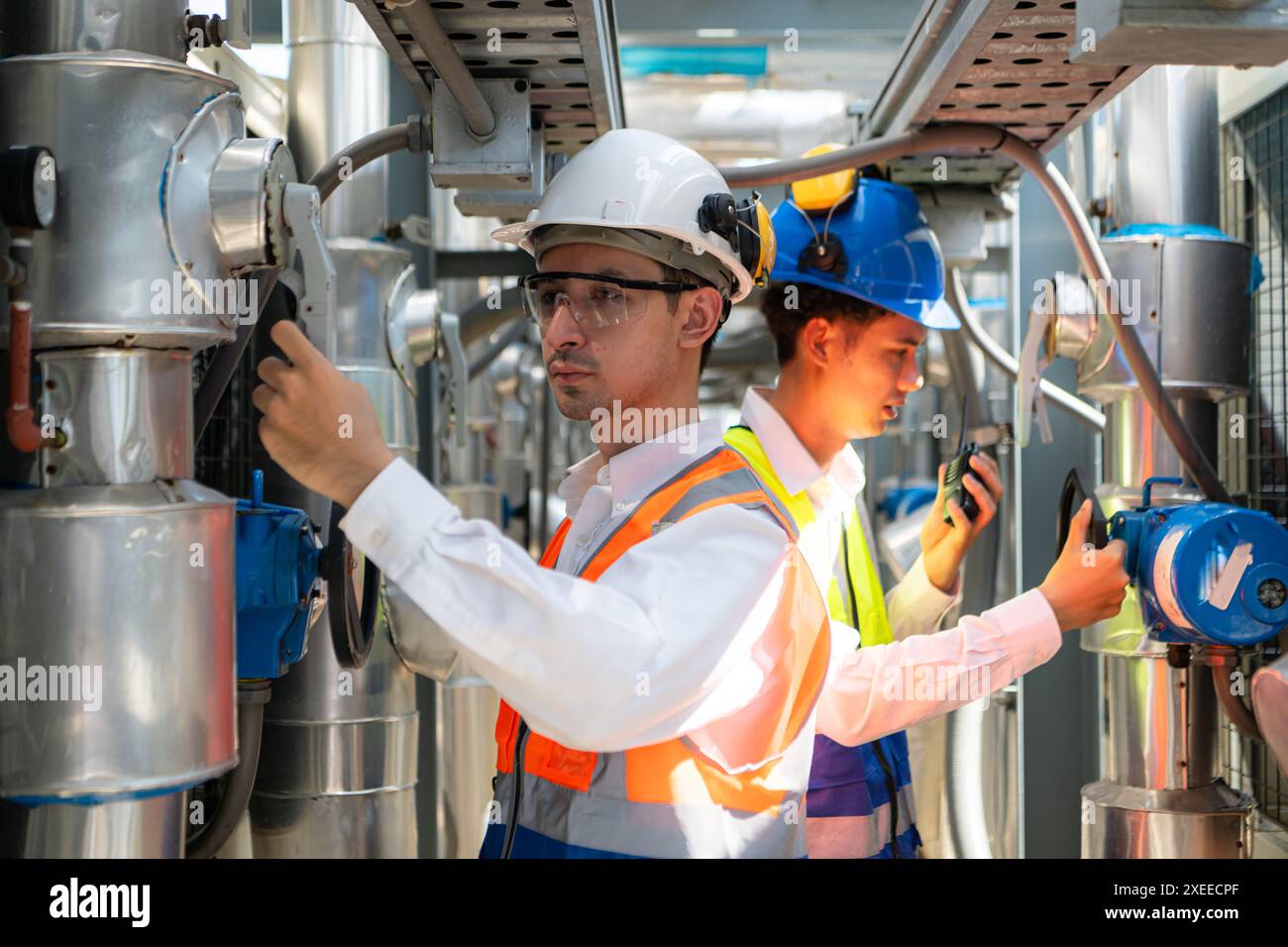 Engineers and technicians Inspect the completed air conditioning and water systems to continue verifying their functionality. Stock Photo