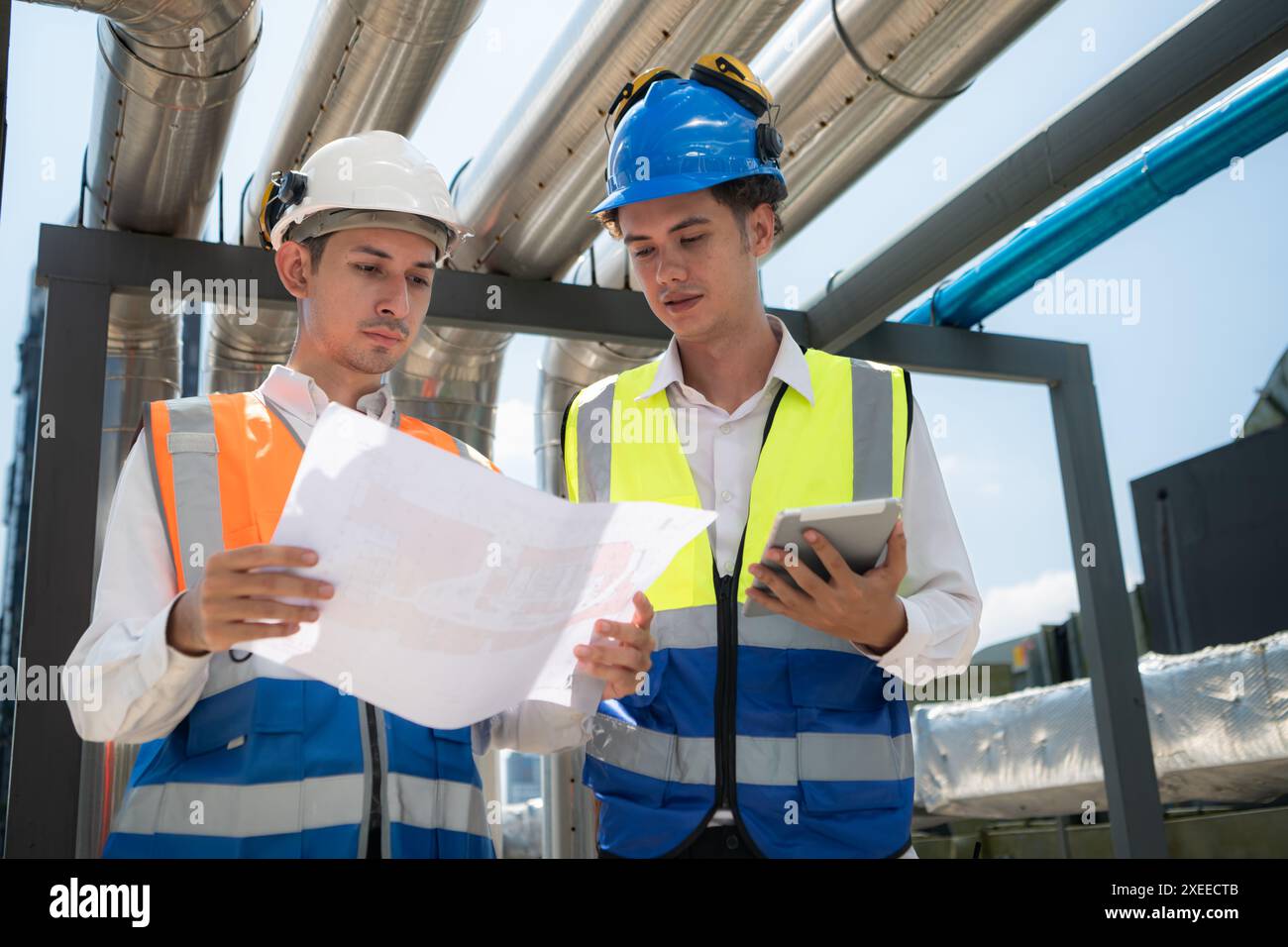 Engineers and technicians Inspect the completed air conditioning and water systems to continue verifying their functionality. Stock Photo