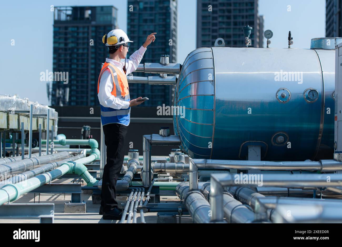 Engineers inspect the completed air conditioning and water systems to continue verifying their functionality. Stock Photo