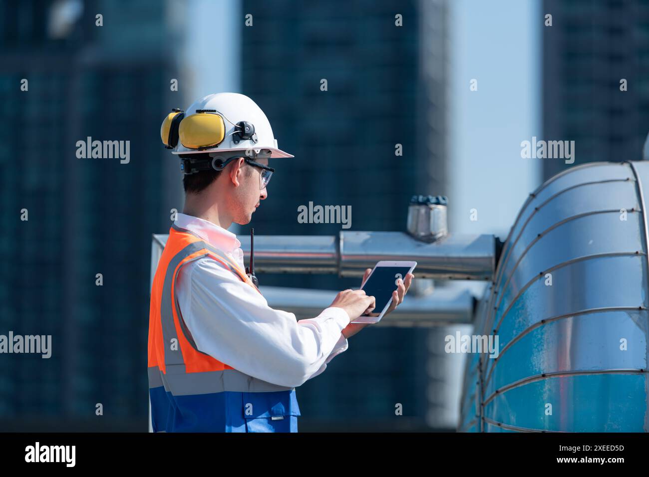 Engineers inspect the completed air conditioning and water systems to continue verifying their functionality. Stock Photo
