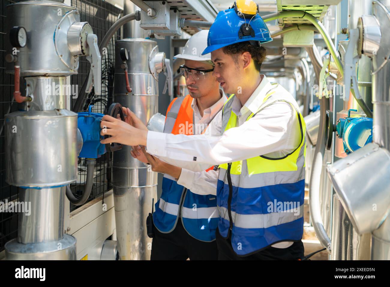 Engineers and technicians Inspect the completed air conditioning and water systems to continue verifying their functionality. Stock Photo
