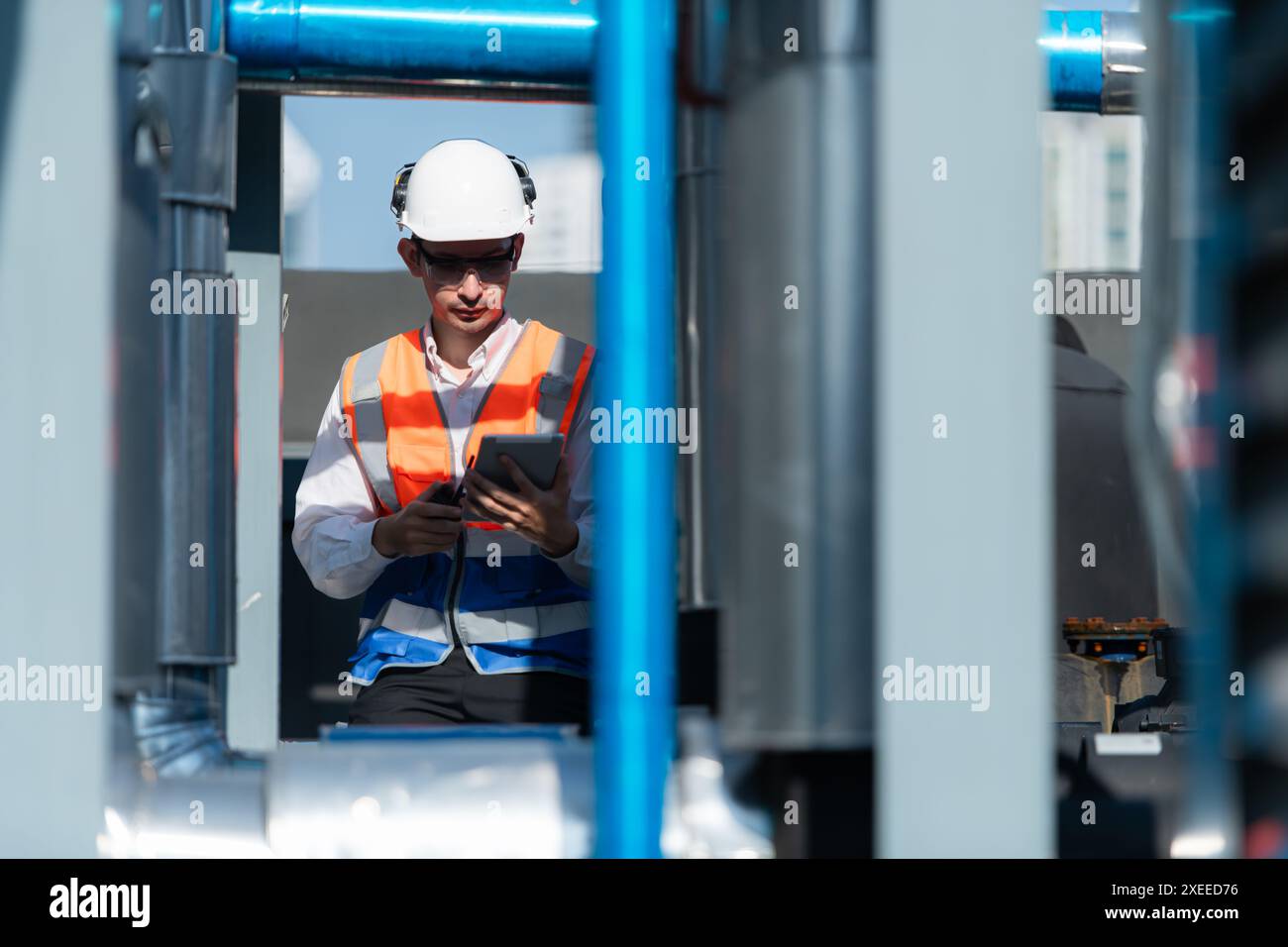 Engineers inspect the completed air conditioning and water systems to continue verifying their functionality. Stock Photo