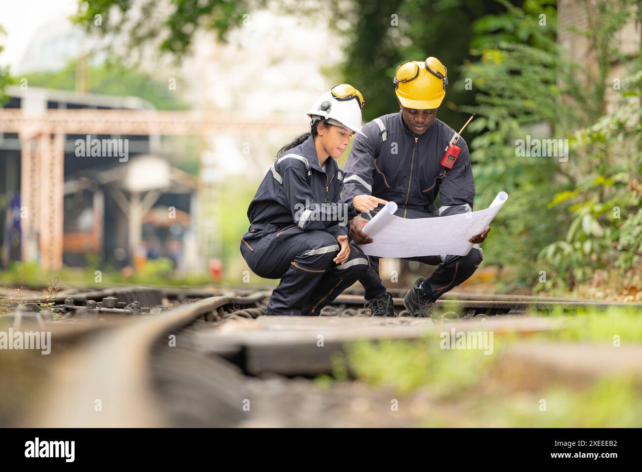 Railway technicians and engineers, Working on the train tracks at train station Stock Photo