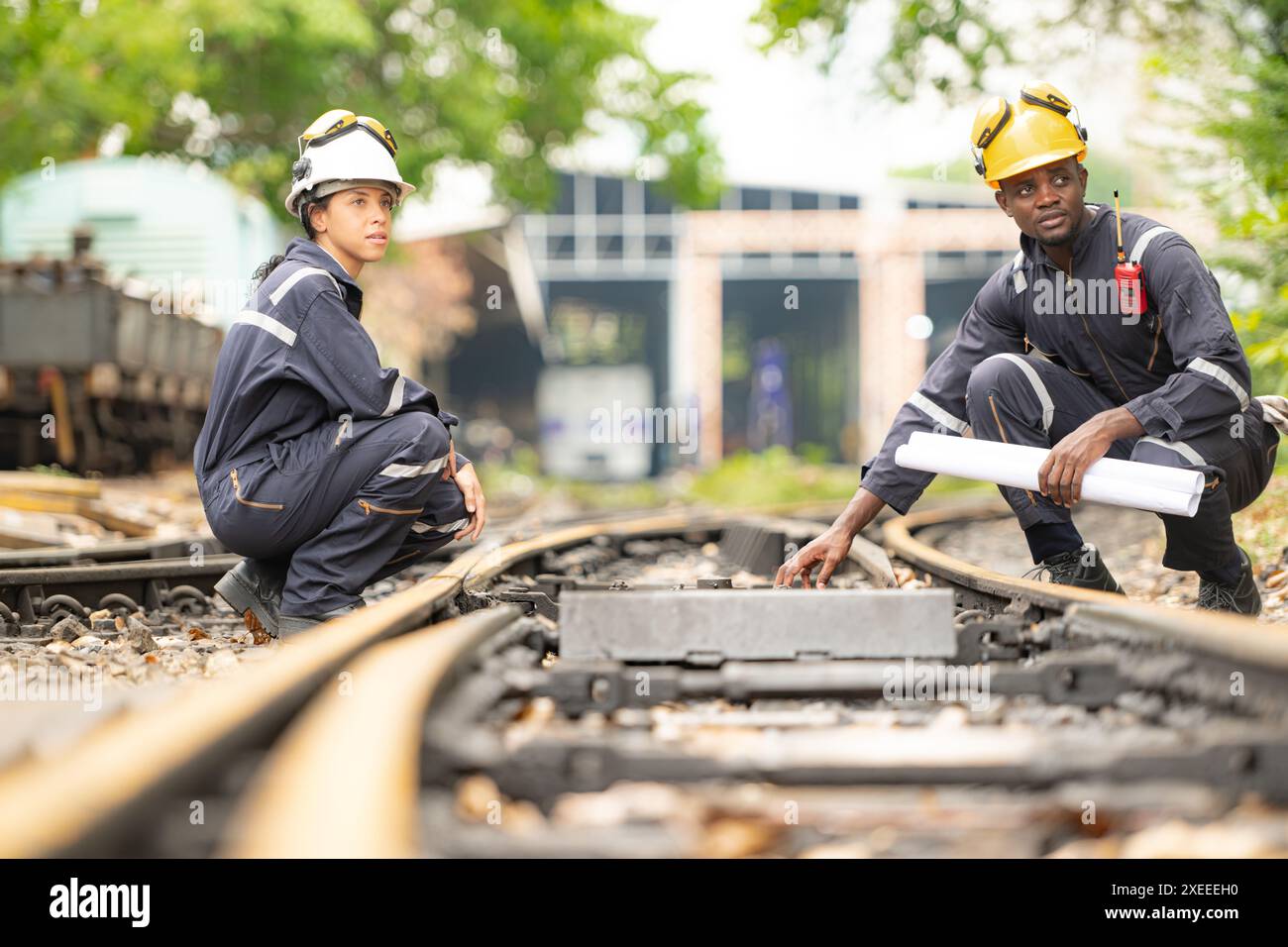 Railway technicians and engineers, Working on the train tracks at train station Stock Photo