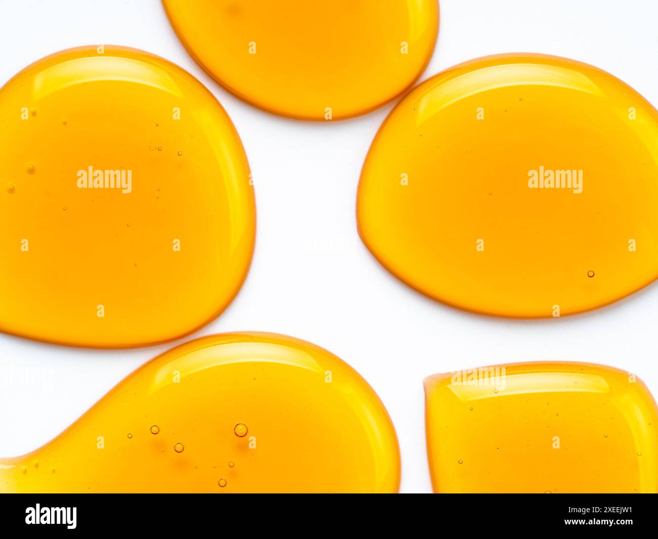 Honey drops abstract pattern, isolated on white Stock Photo