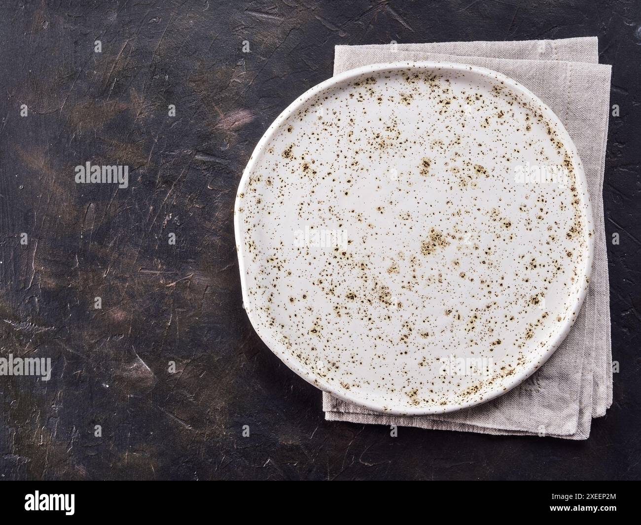 White craft plate on black slate table Stock Photo