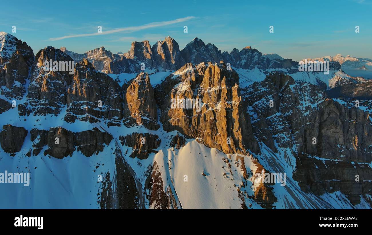 Rocky snow mountains at sunrise aerial Stock Photo