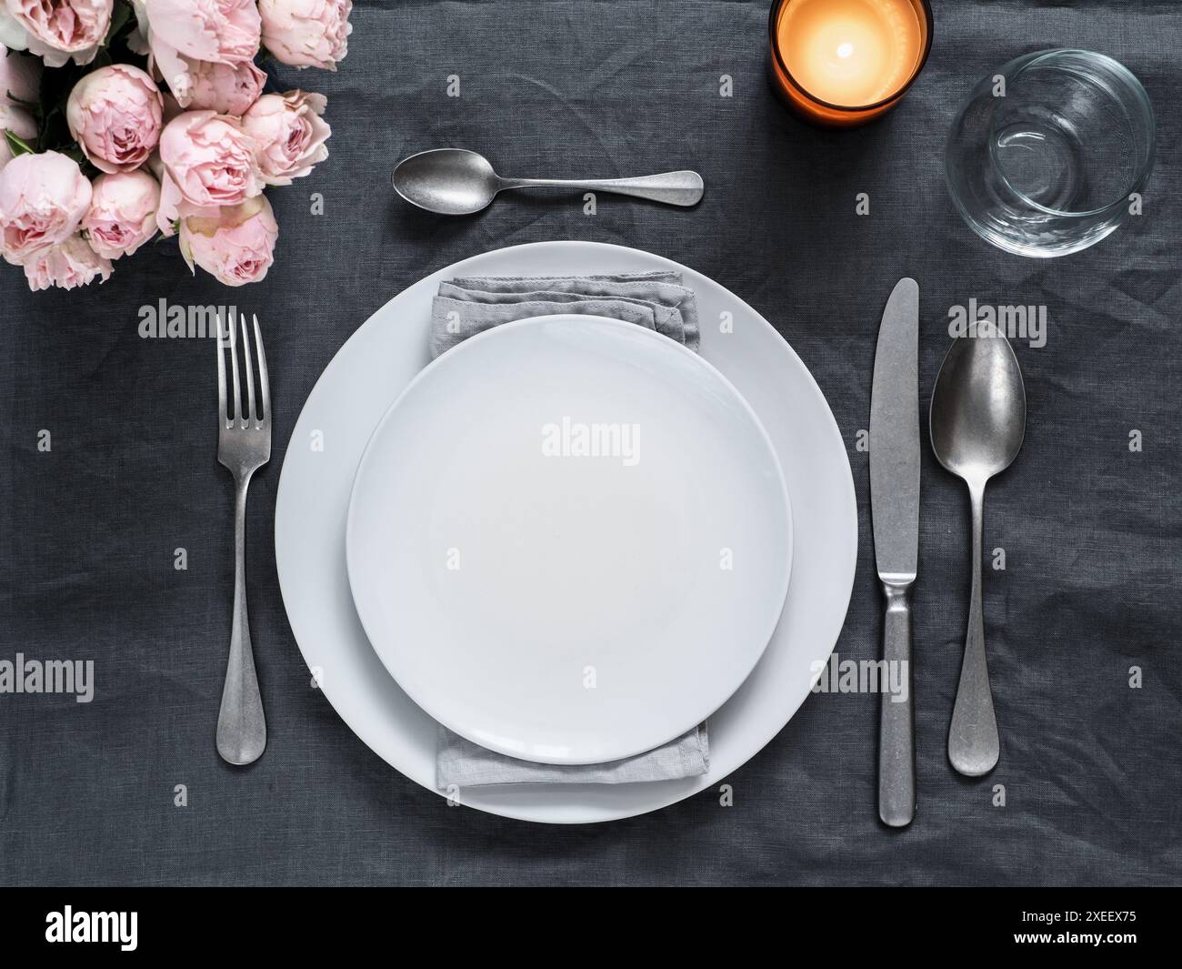 Beautiful table setting on gray linen tablecloth Stock Photo