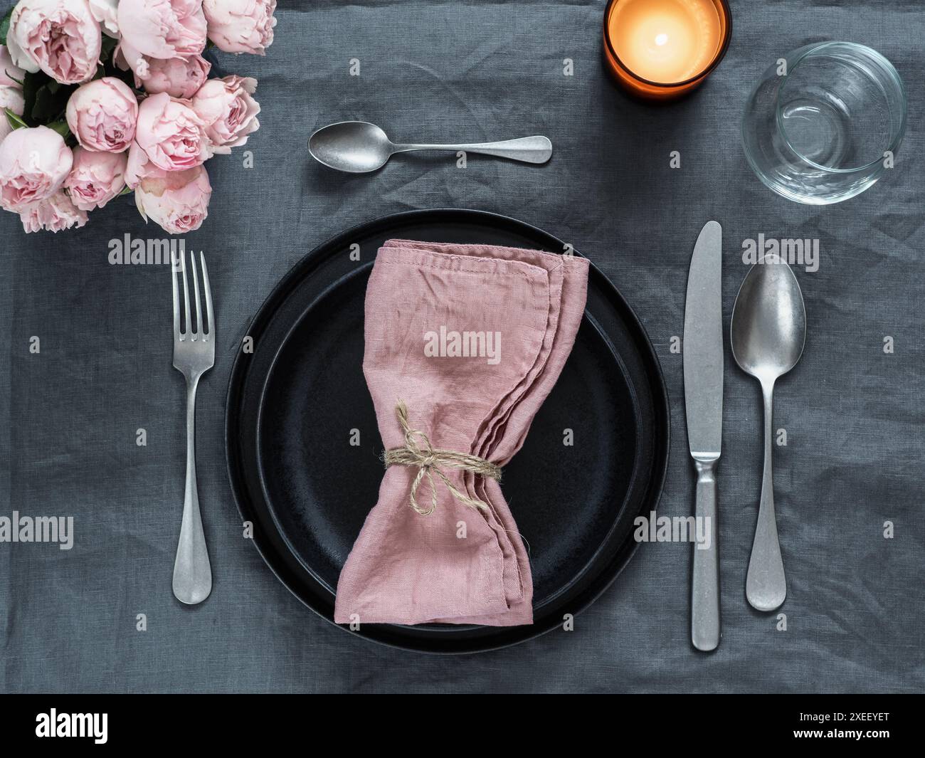 Beautiful table setting on gray linen tablecloth Stock Photo