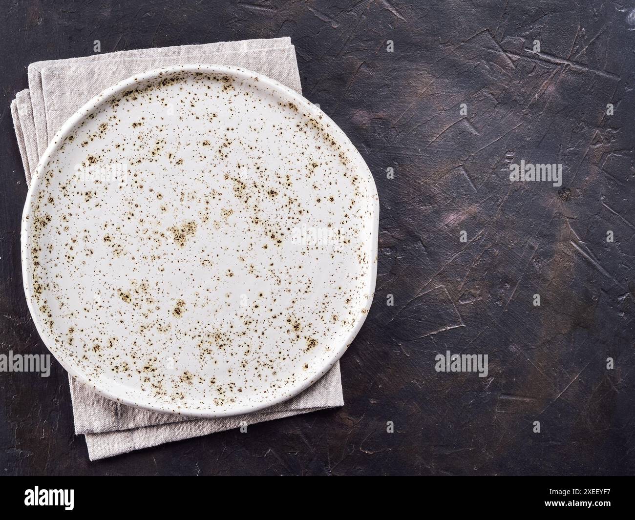 White craft plate on black slate table Stock Photo