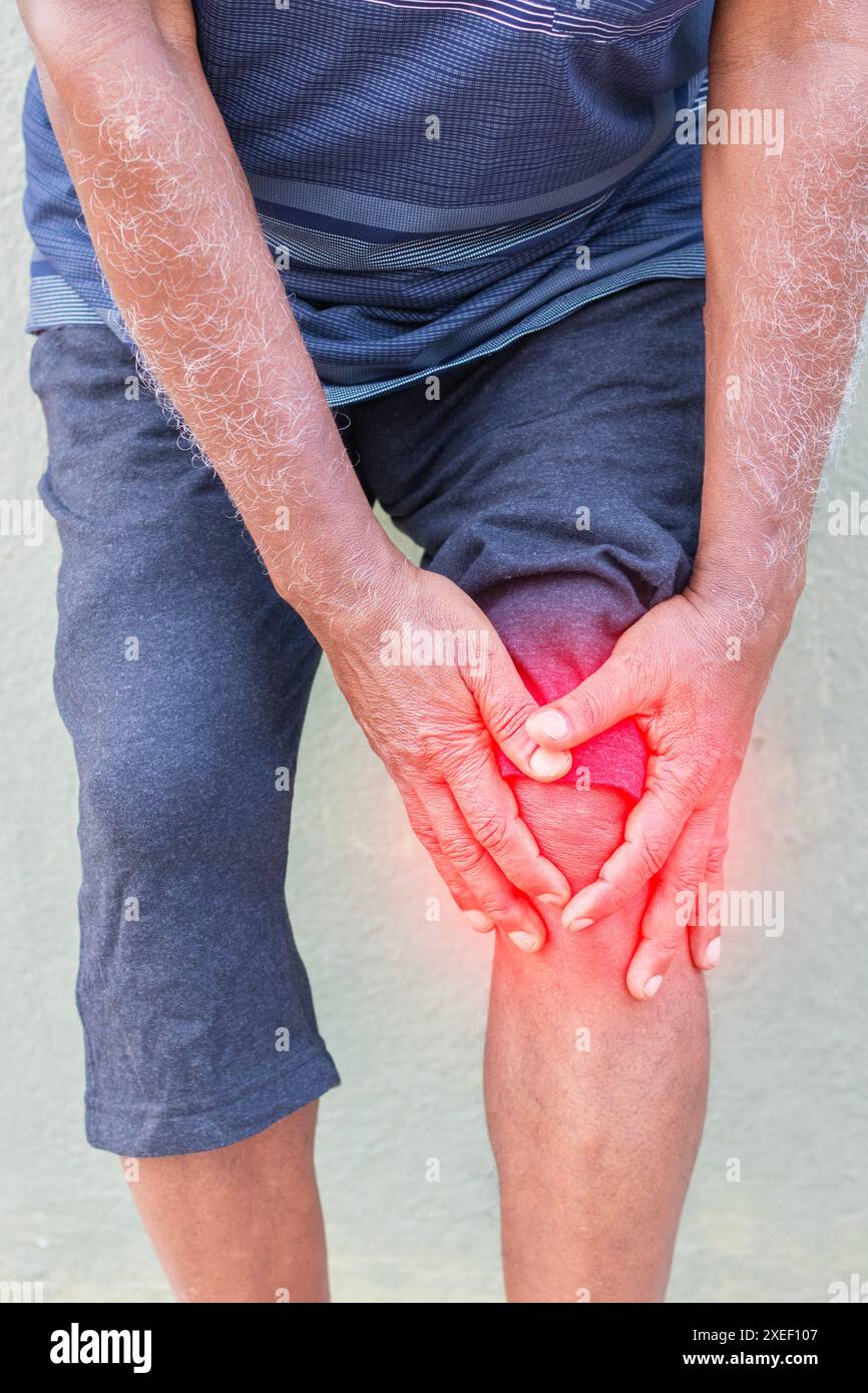 Imitative presentation of old man above sixty feeling knee pain or gout problem. Stock Photo