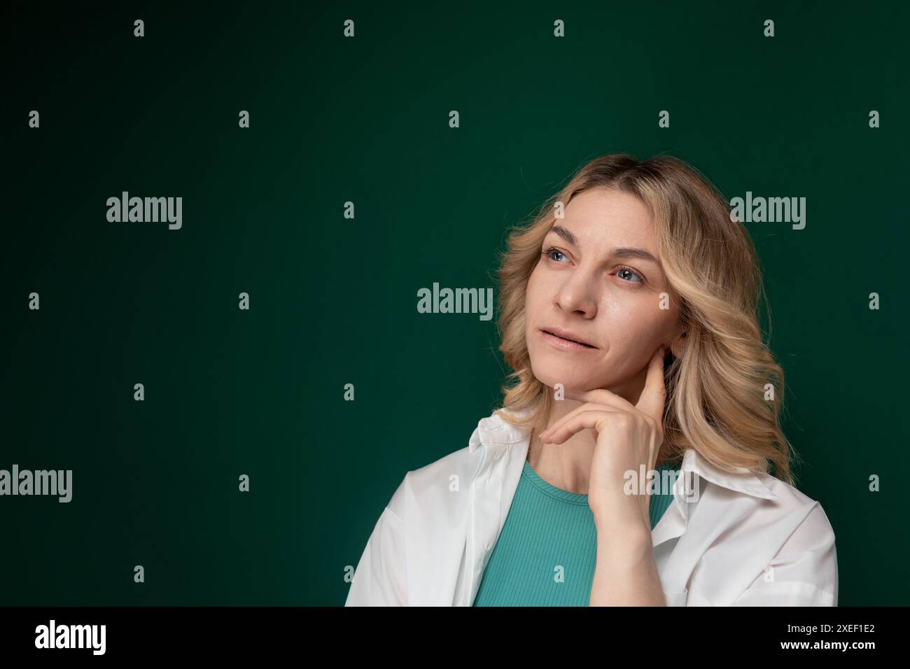 Woman Posing in Front of Green Background Stock Photo