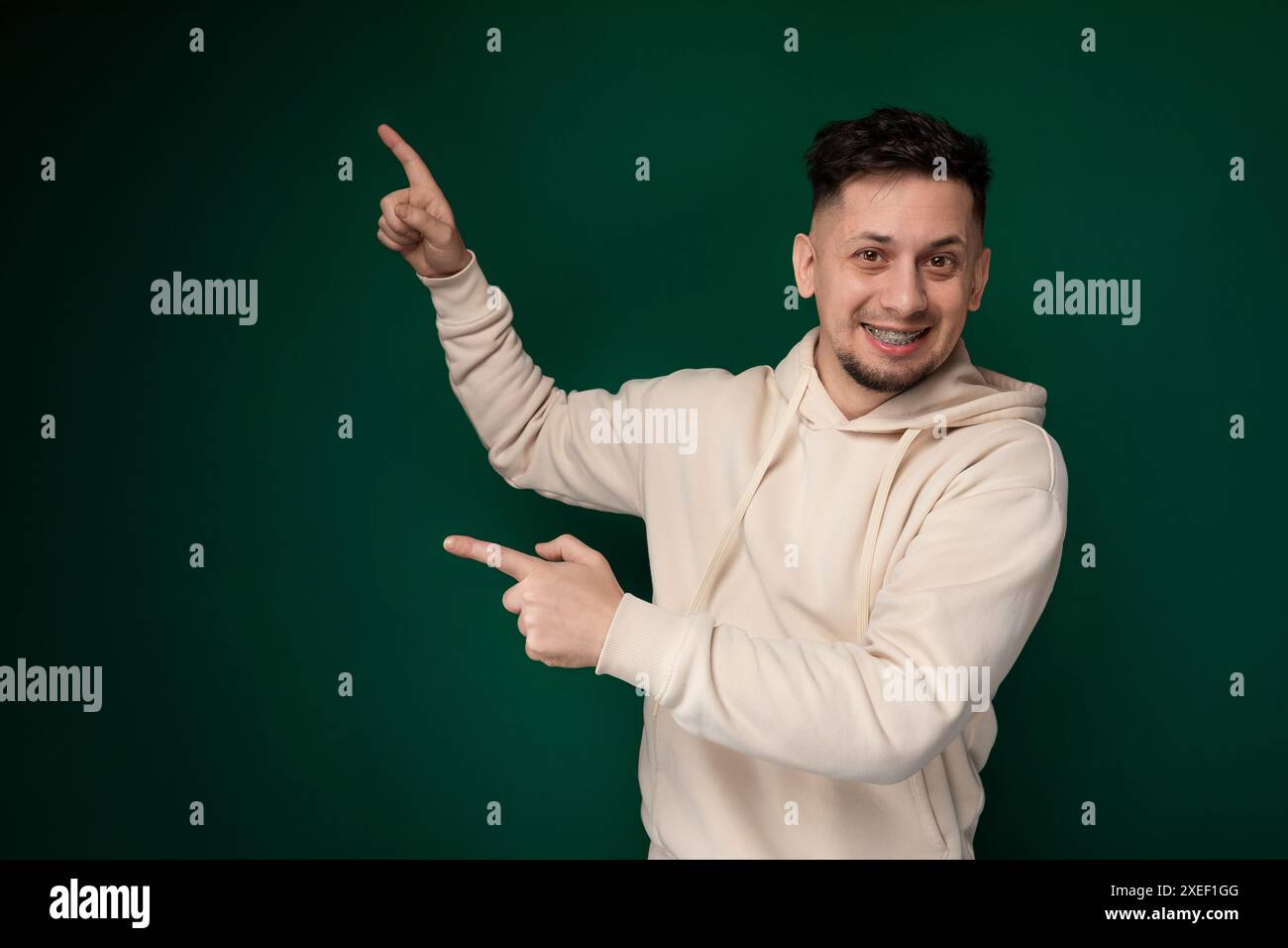 Man in White Hoodie Pointing at Something Stock Photo
