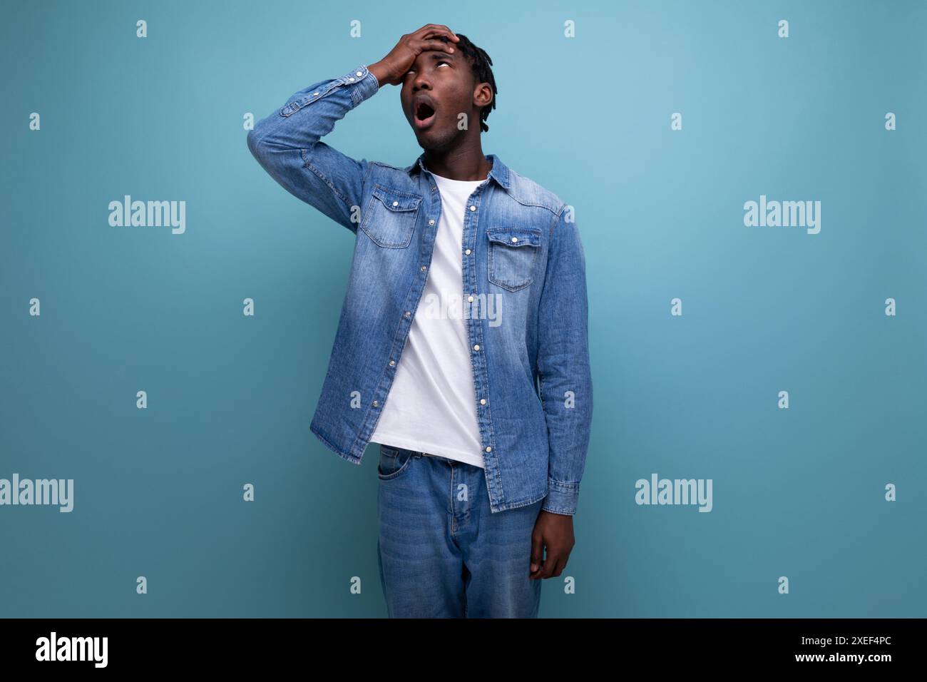 Pensive american man with afro curls in casual denim jacket Stock Photo