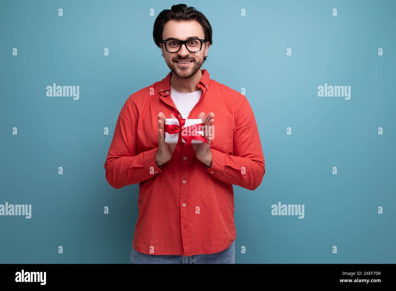 Cute happy young brunette man got a lovely birthday present Stock Photo