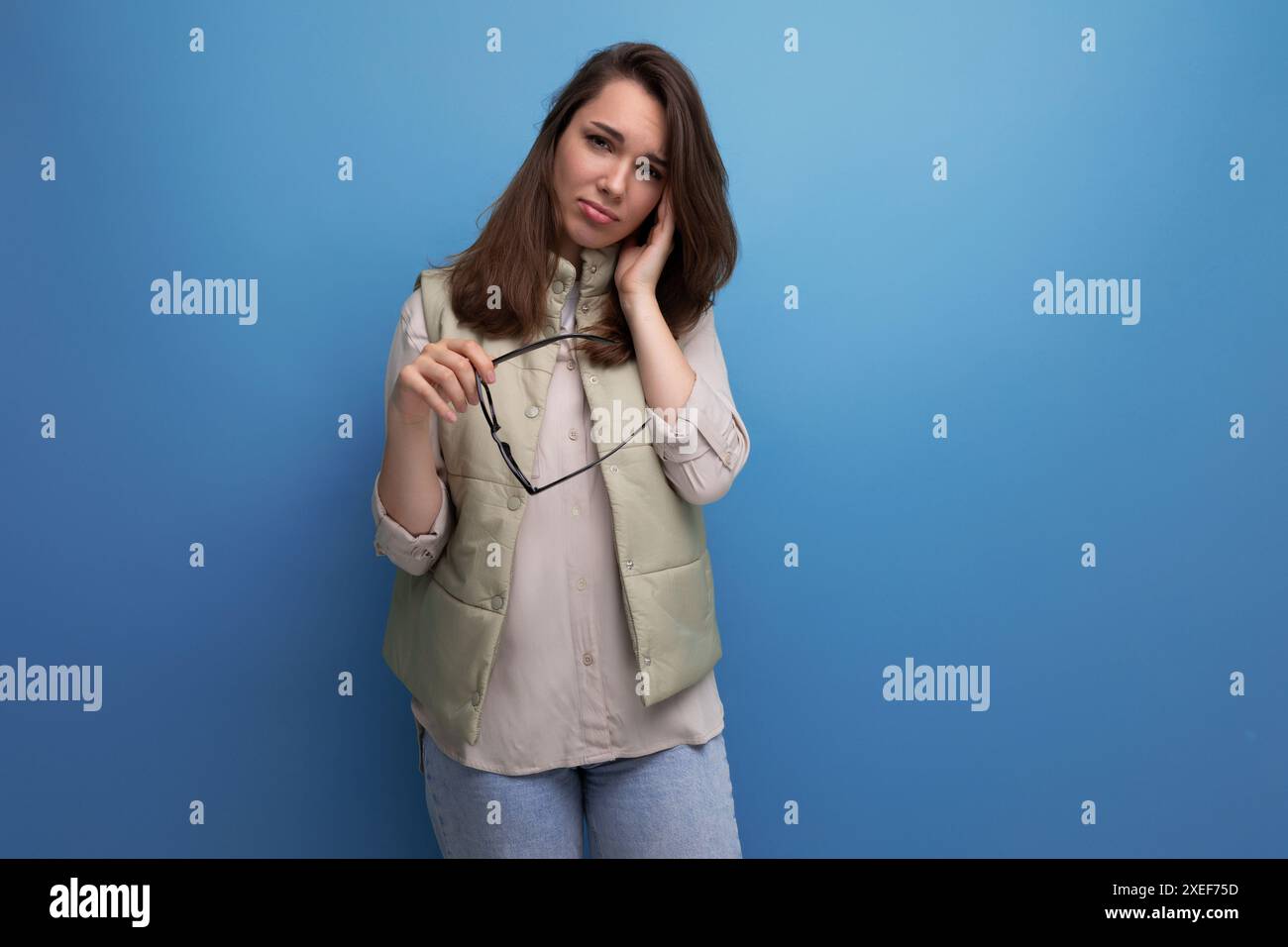 Tired young brunette woman in everyday experience discomfort from