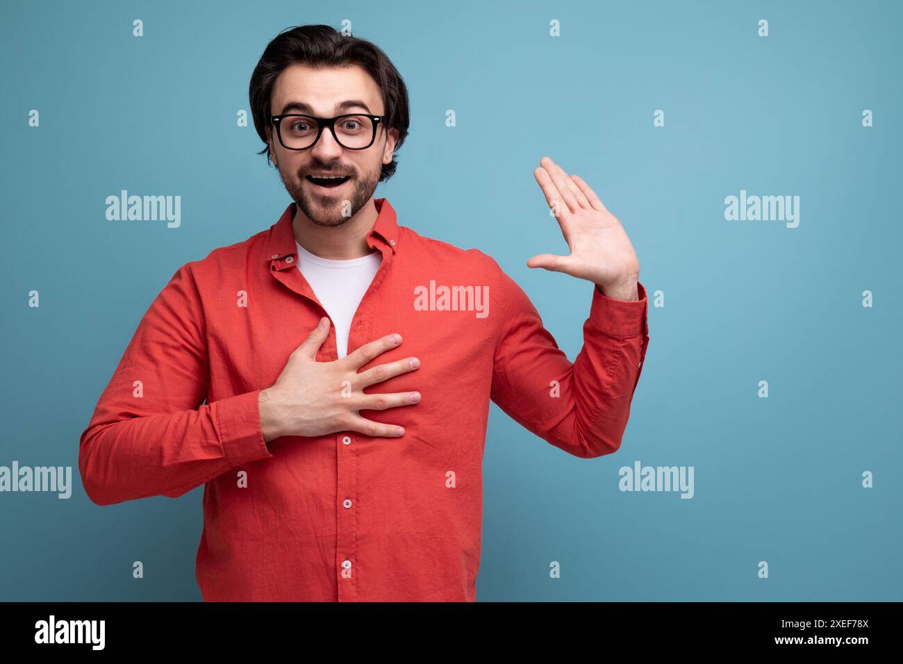Smart handsome young brunette man with glasses explains an idea Stock Photo
