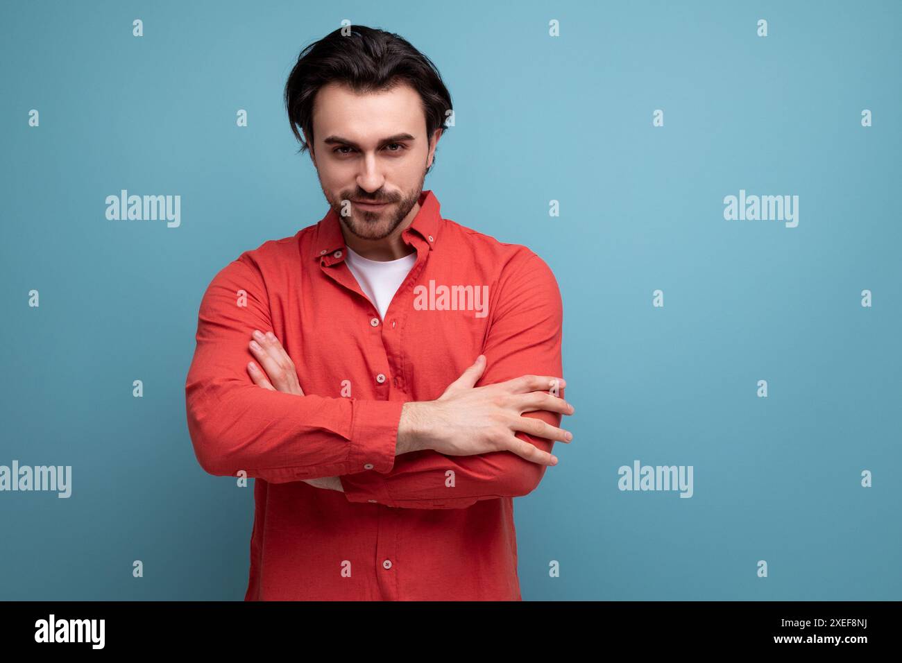 Handsome confident dark haired 30s man in red shirt Stock Photo