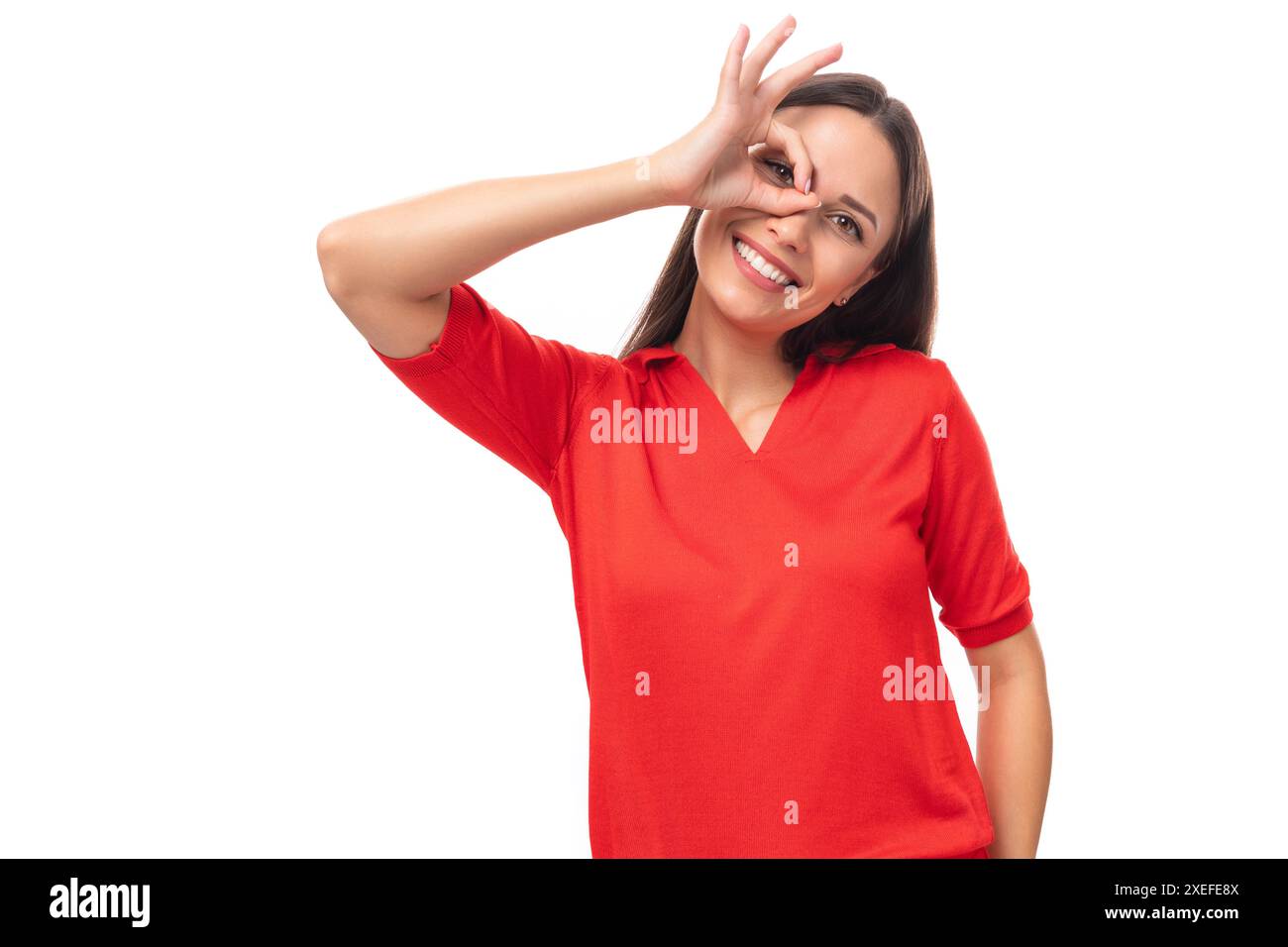 Close-up portrait of a funny young european brunette lady in a red t-shirt with a grimace Stock Photo