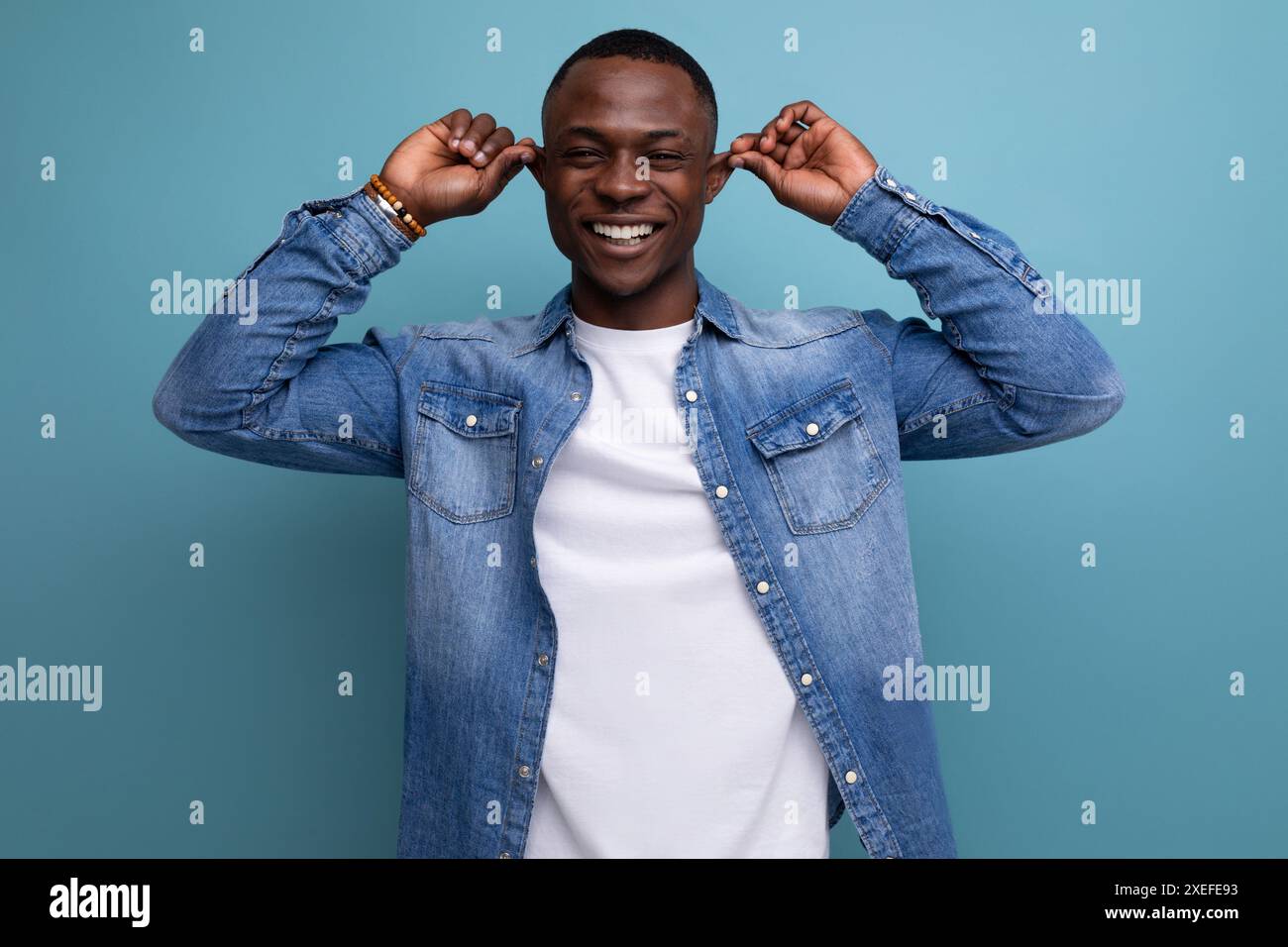 Handsome confused young attractive african man dressed casually in denim Stock Photo