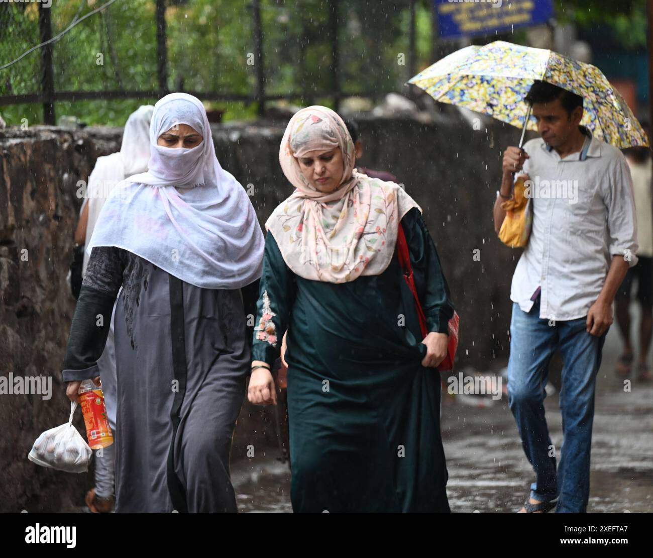 NEW DELHI, INDIA JUNE 27 People during heavy rain in the morning at