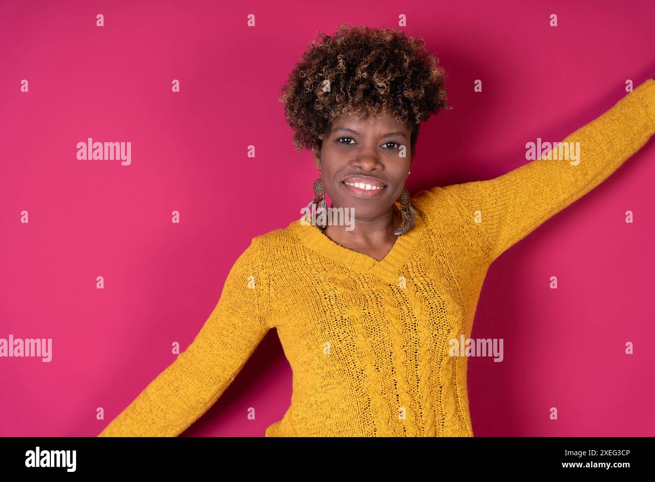 Woman in yellow sweater wearing hi-res stock photography and images - Alamy
