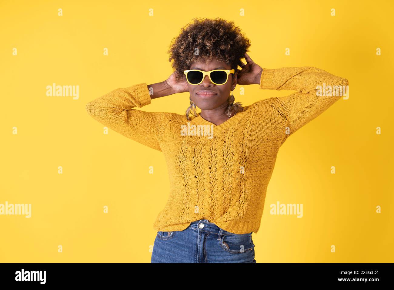 Woman in yellow sweater wearing hi-res stock photography and images - Alamy