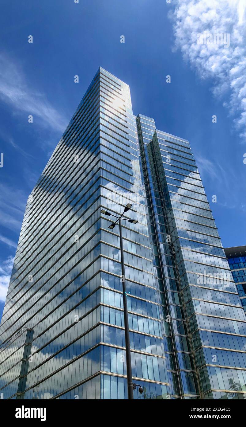 Modern Skyscraper Reaching into the Blue Sky with Fluffy Clouds Stock ...