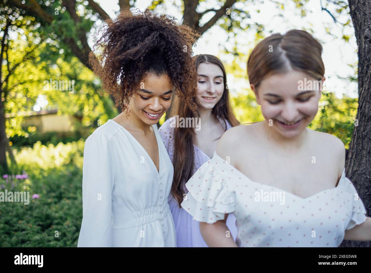 Three happy pretty smiling teenage girls in white summer elegant ...