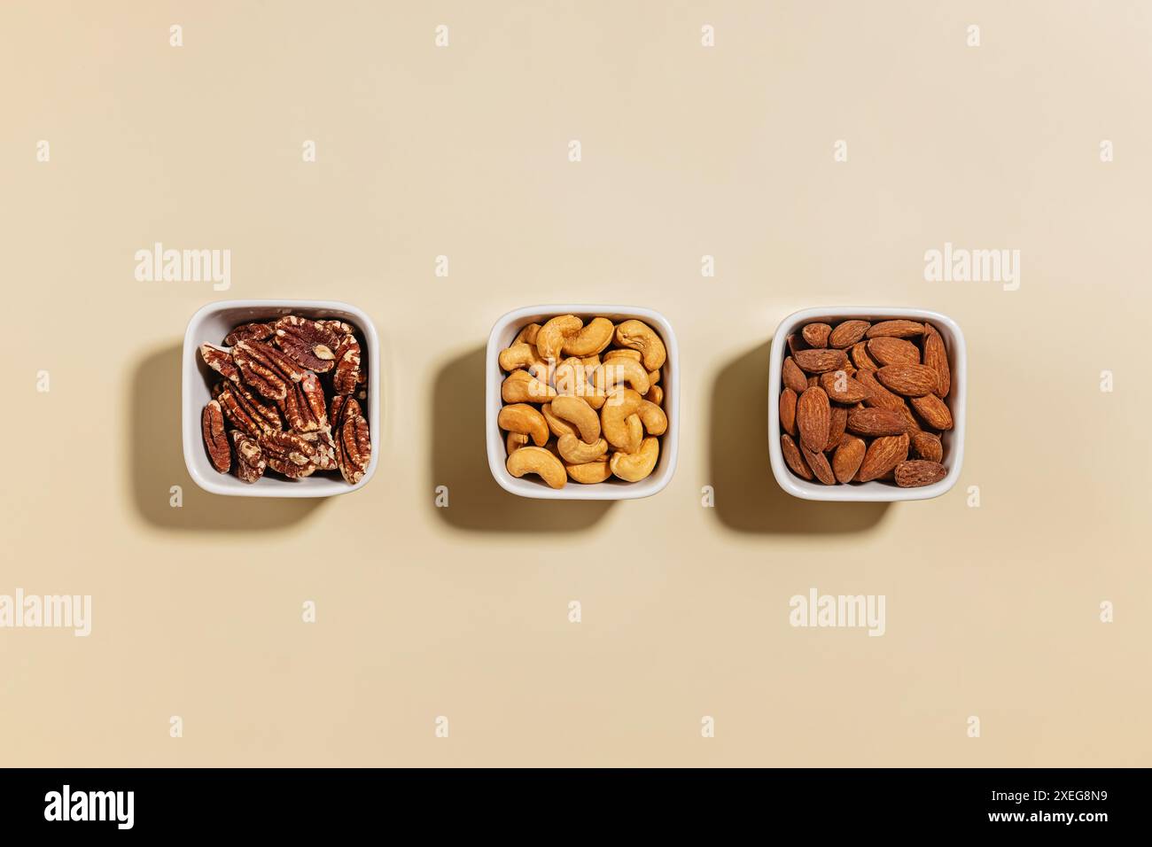 Various dry nuts in a small bowls, overhead view Stock Photo