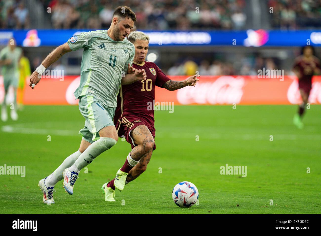 Mexico forward Santiago Giménez (11) is defended by Venezuela midfielder Yeferson Soteldo (10) during the Copa América group stage, Wednesday, June 26 Stock Photo