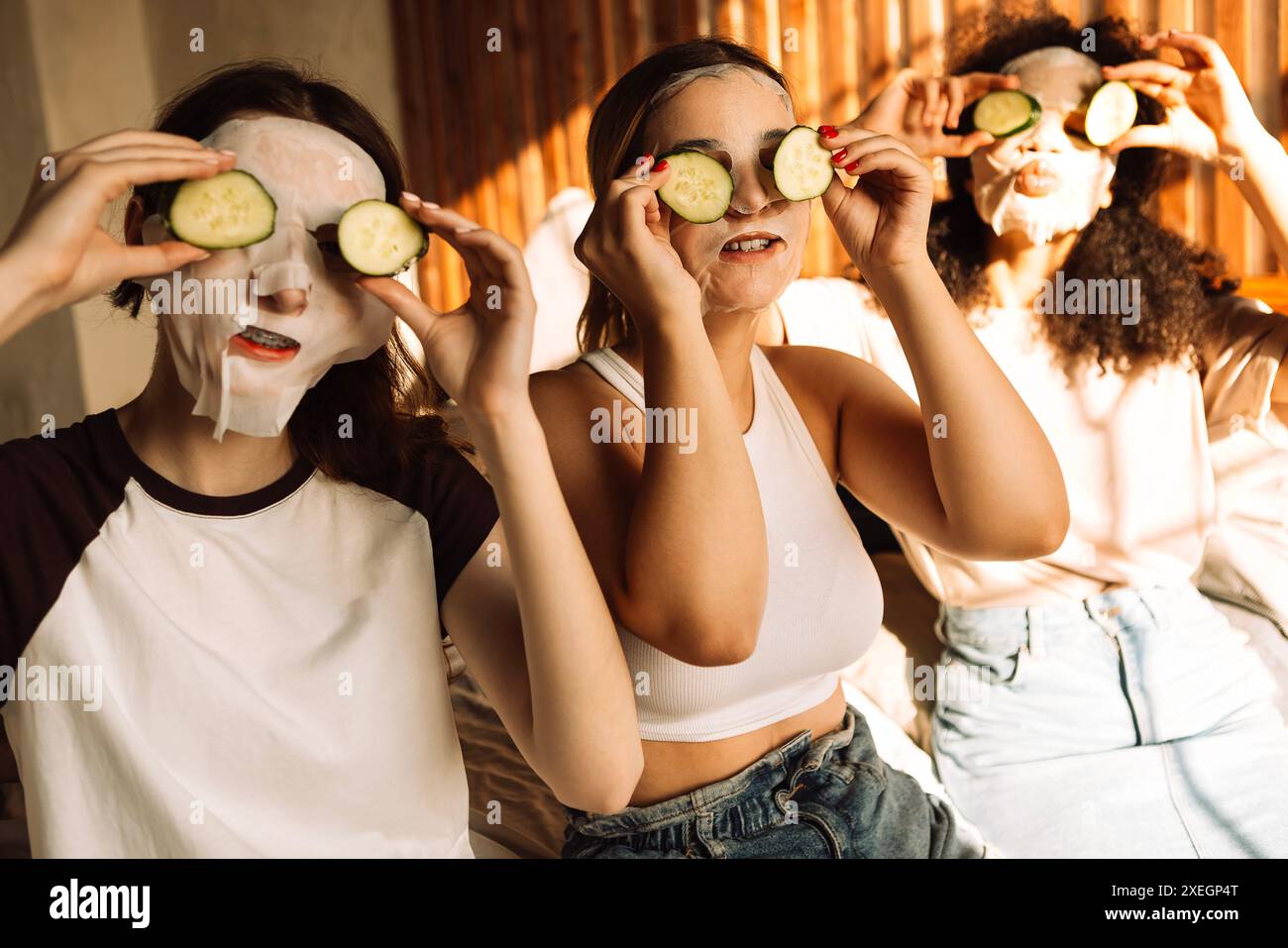 Teenagers of different races wearing cosmetic masks on their faces and ...