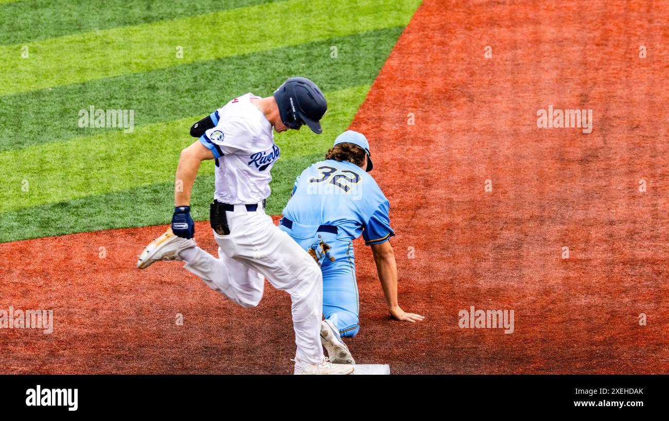 Edmonton, Canada. 26th June, 2024. (L-R) Edmonton Riverhawk (3B) Jakob Poturnak gets put out on a at first by Bellingham (1B) Jacob Mejia in the 1st inning of the game against the Bellingham Bells of the West Coast League at Remax Field. Edmonton River Hawks 4:8 Bellingham Bells (Photo by Ron Palmer/SOPA Images/Sipa USA) Credit: Sipa USA/Alamy Live News Stock Photo