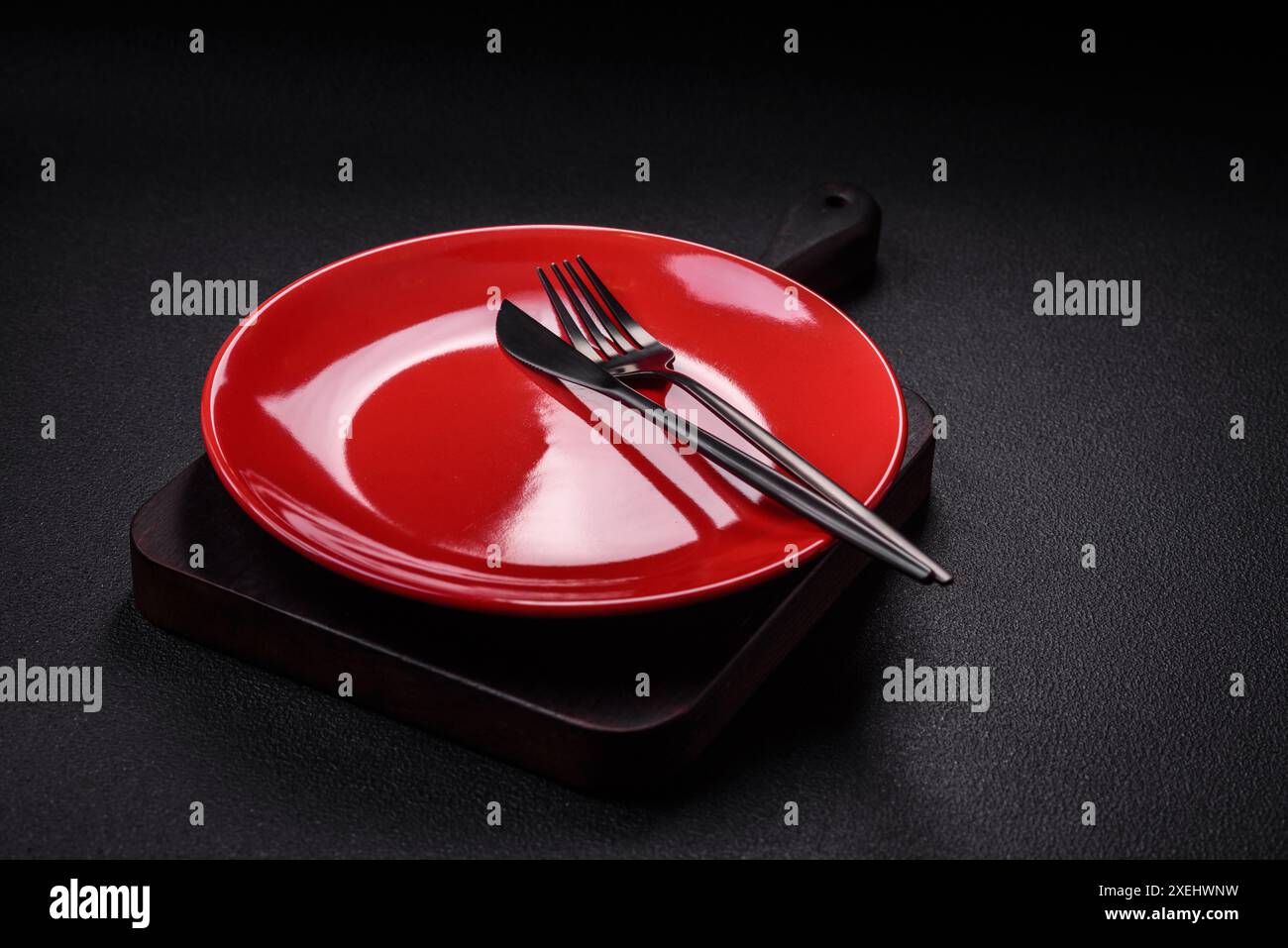 Bumpy empty ceramic plate on a textured concrete background Stock Photo ...