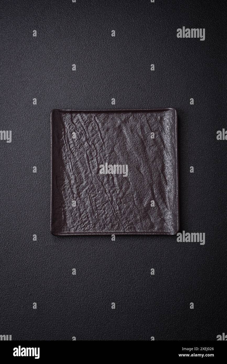Square empty ceramic plate on textured concrete background Stock Photo