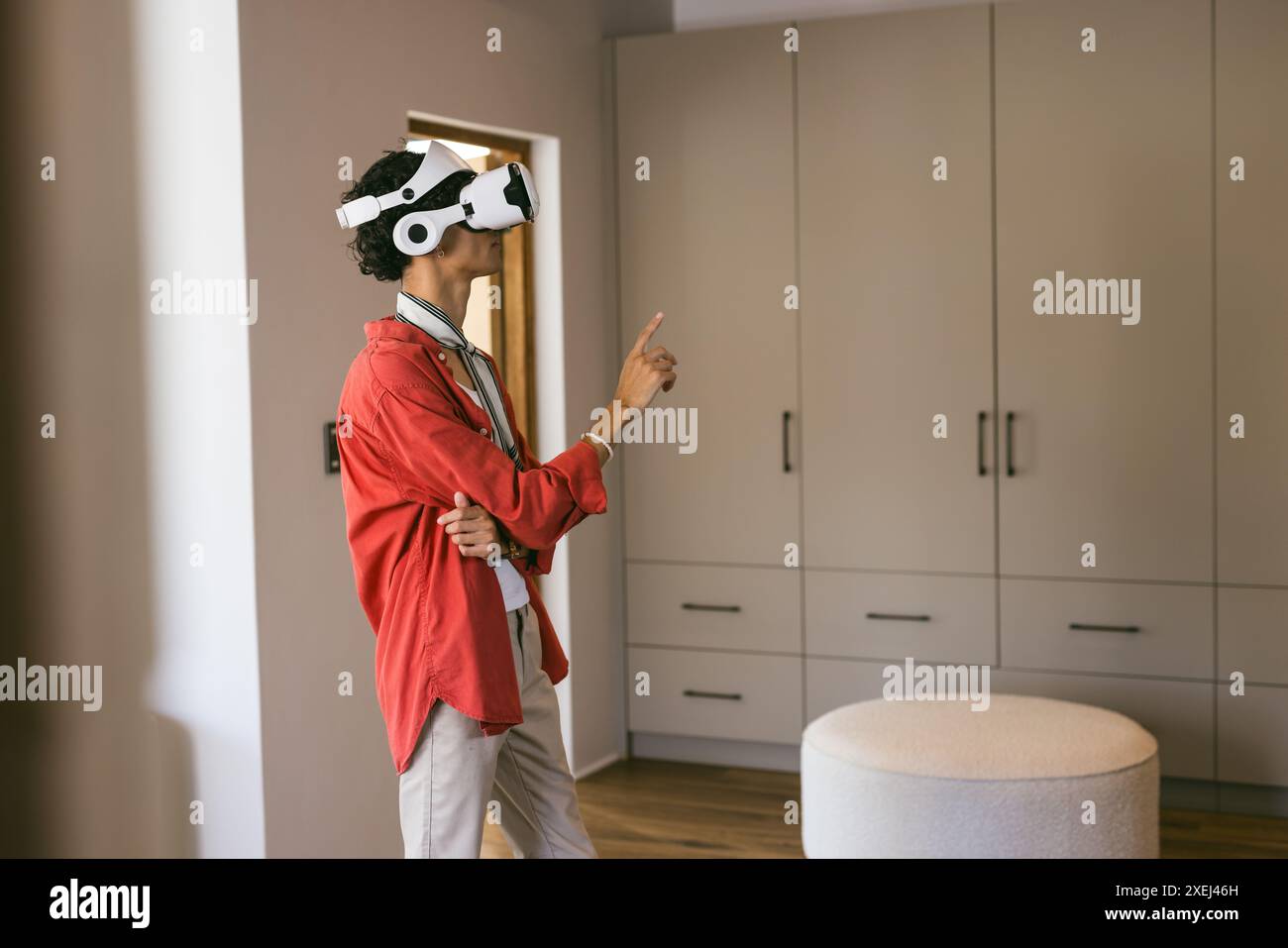Using VR headset, young man exploring virtual environment in modern ...