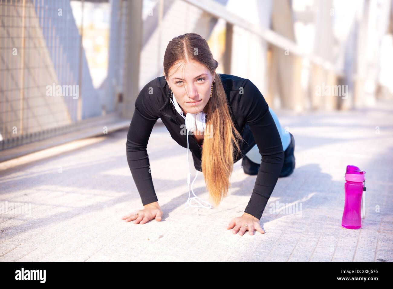 Active runner doing warm-up push-ups for running or cardio. Stock Photo