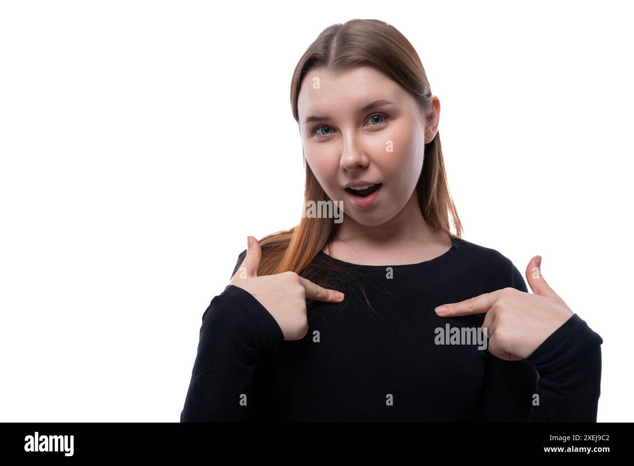 Confident school-age girl with brown hair on a white studio background Stock Photo