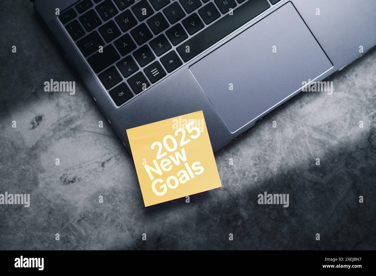 Business goals trends 2024. Adhesive note on laptop for 2025 new goals