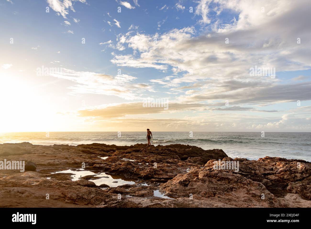 Woman walking on rocky shore hi-res stock photography and images - Alamy