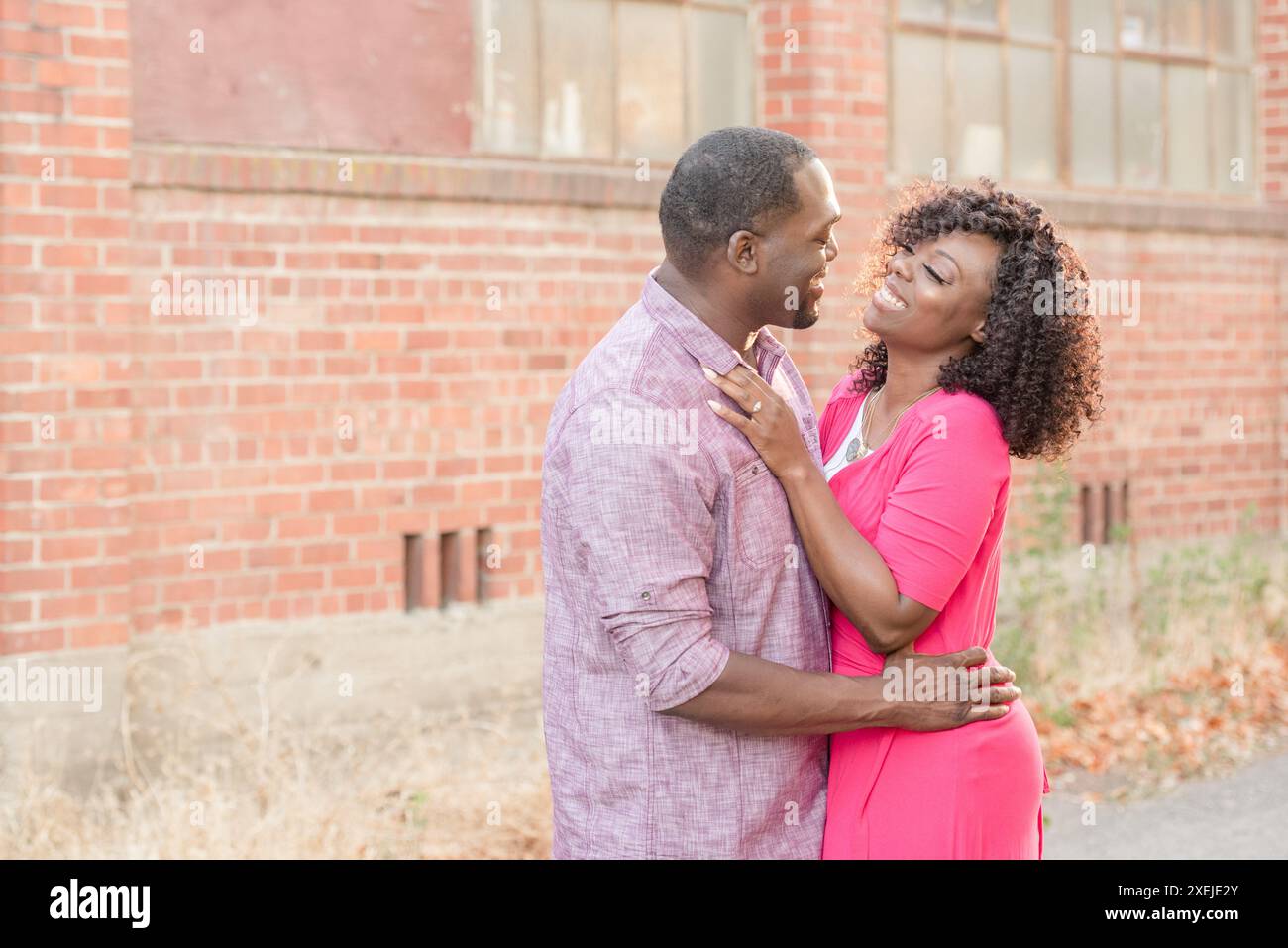 Woman and man laughing together looking into each others eyes Stock ...