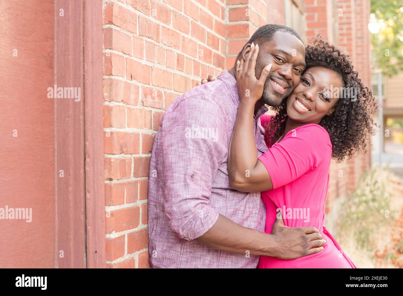 Young couple holding each other smiling at camera Stock Photo