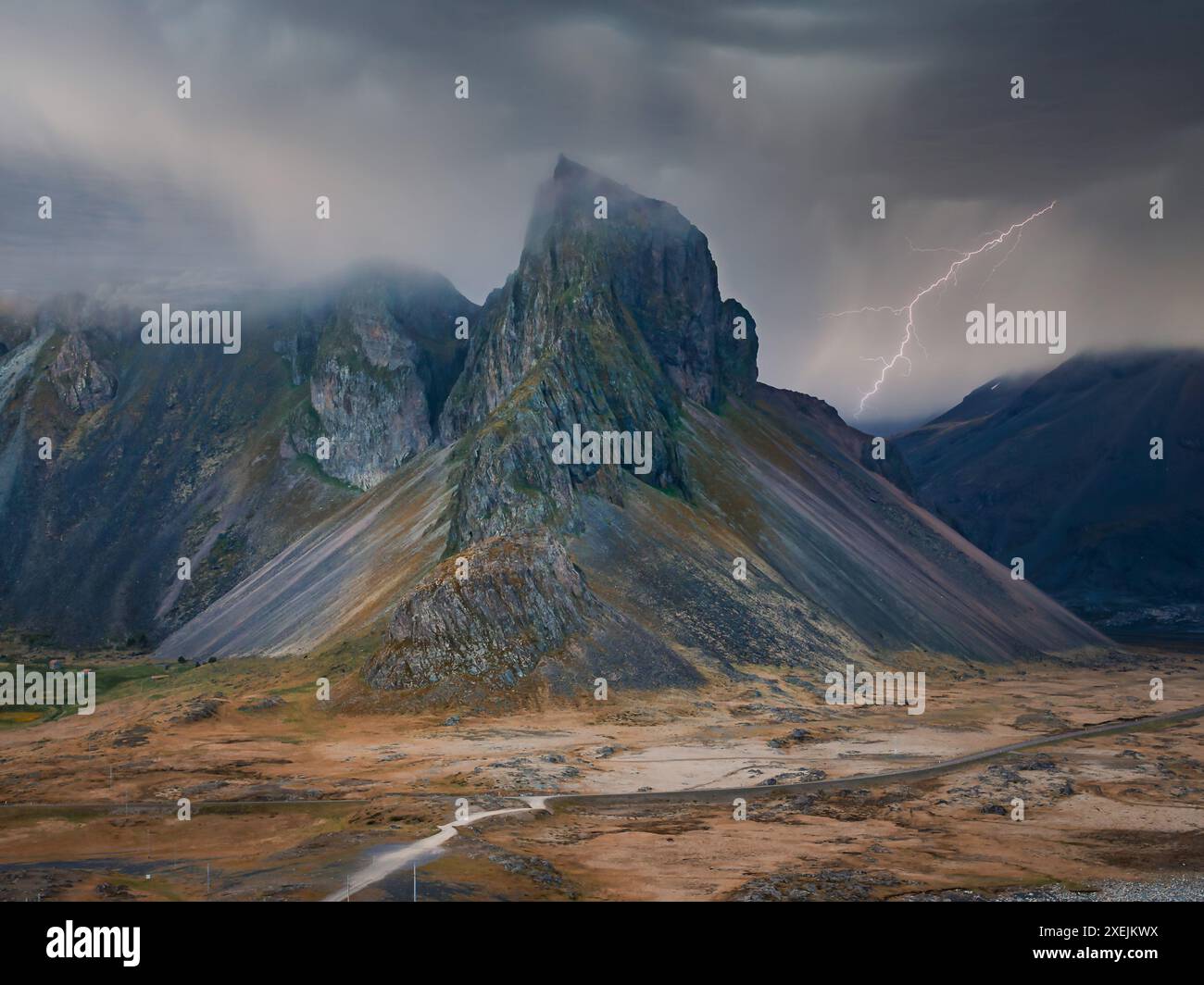 Lightning Strike Illuminates Dramatic Mountain Range in Iceland Stock Photo