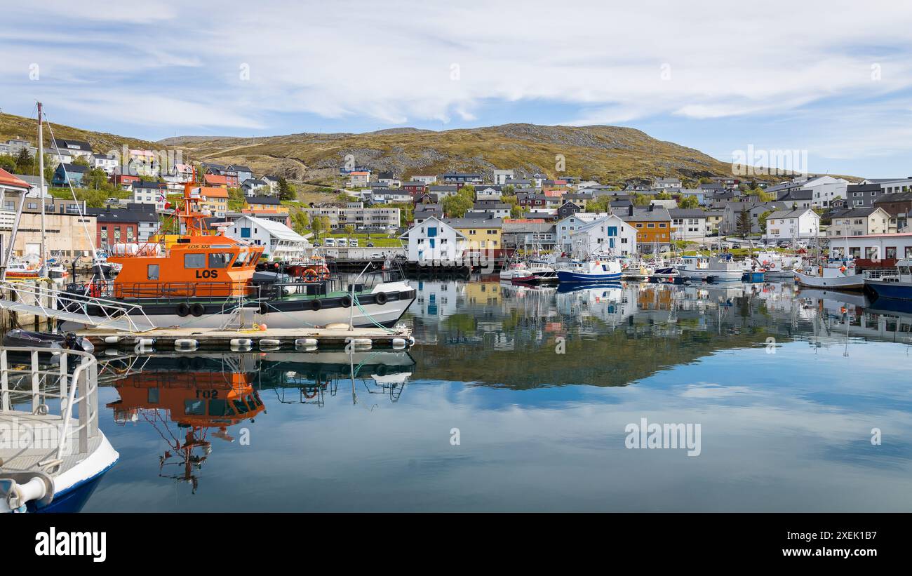 HonningsvÃ¥g, Norway - June 11, 2023: Harbor of HonningsvÃ¥g with little boats and part of the village Stock Photo