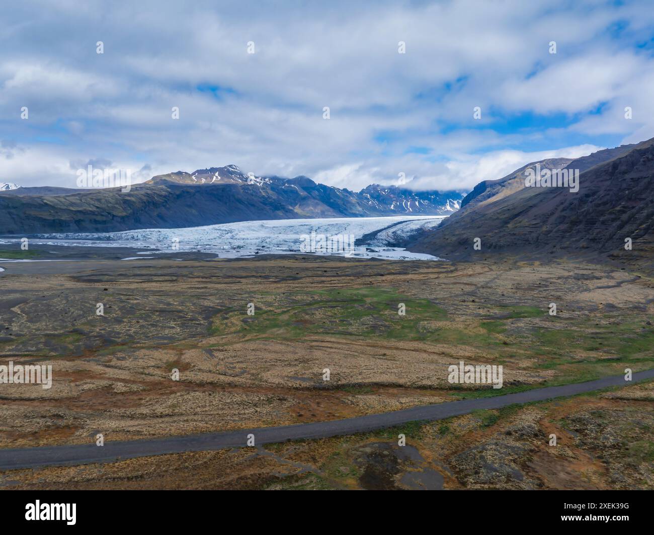 Aerial View of Icelandic Glacier with Surrounding Mountains and Road Stock Photo