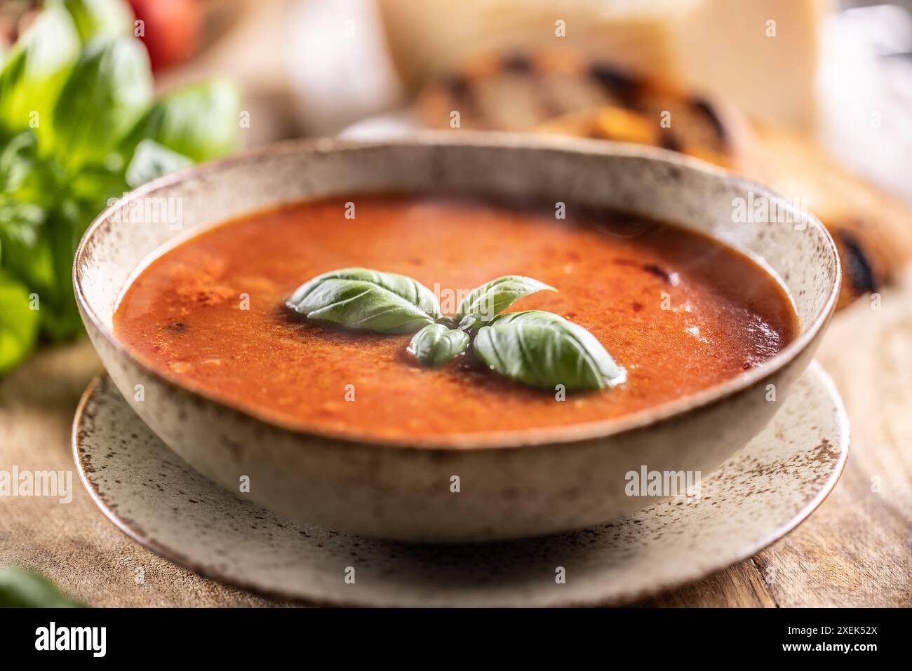 Healthy vegetarian tomato soup with parmesan and basil. Italian and Mediterranean food. Stock Photo
