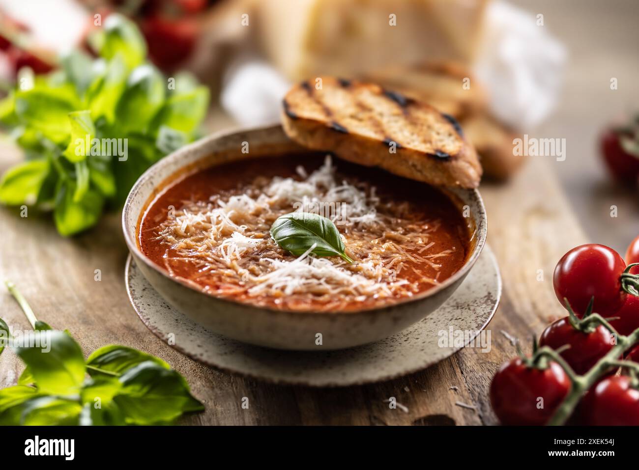 Healthy vegetarian tomato soup with parmesan and basil. Italian and Mediterranean food. Stock Photo