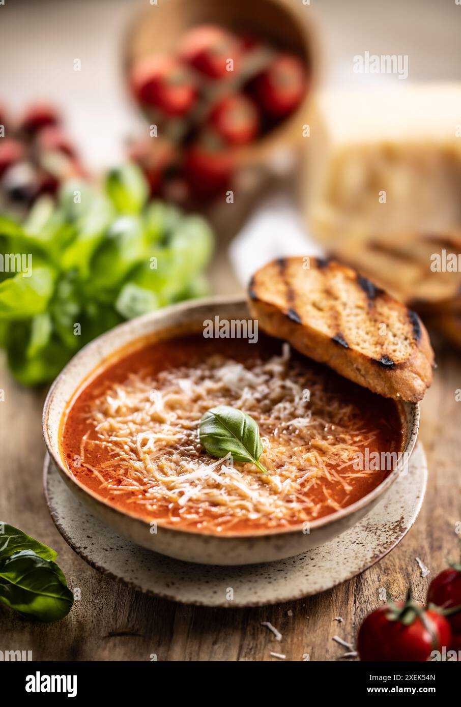 Healthy vegetarian tomato soup with parmesan and basil. Italian and Mediterranean food. Stock Photo