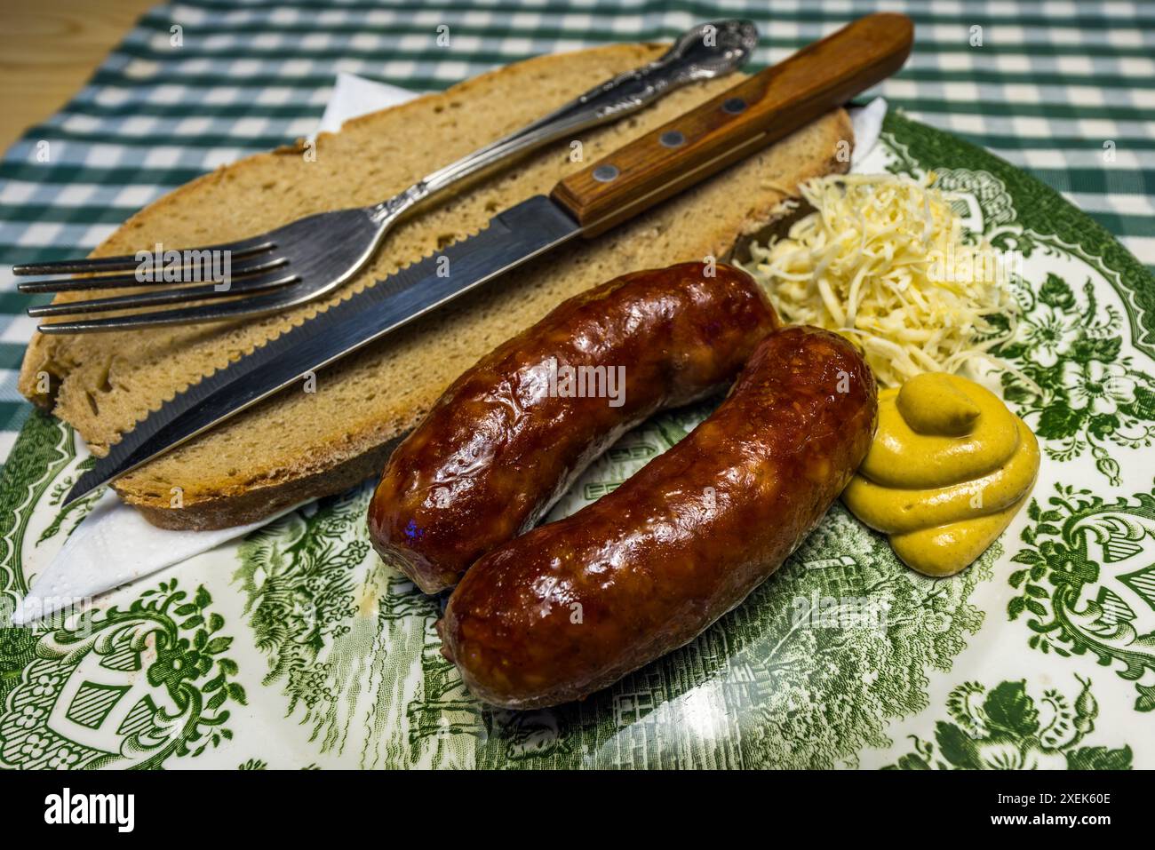 Cheese sausages with mustard, horseradish and farmhouse bread. The sausages are made from beef and pork and also contain pieces of cheese. Typical dish on a mountain farm in the Grossarl Valley. All the main ingredients of the dishes on offer must come from the farm's own production. Homemade sausages with mustard, bread and horseradish. Filzmoosalm, Großarl, Salzburg, Austria Stock Photo